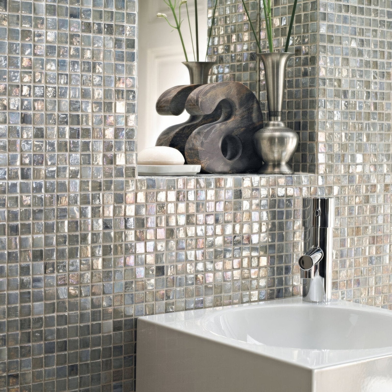 Shiny silver malacassa spa square mosaic tile wall with modern bathroom sink and chrome faucet in a contemporary setting