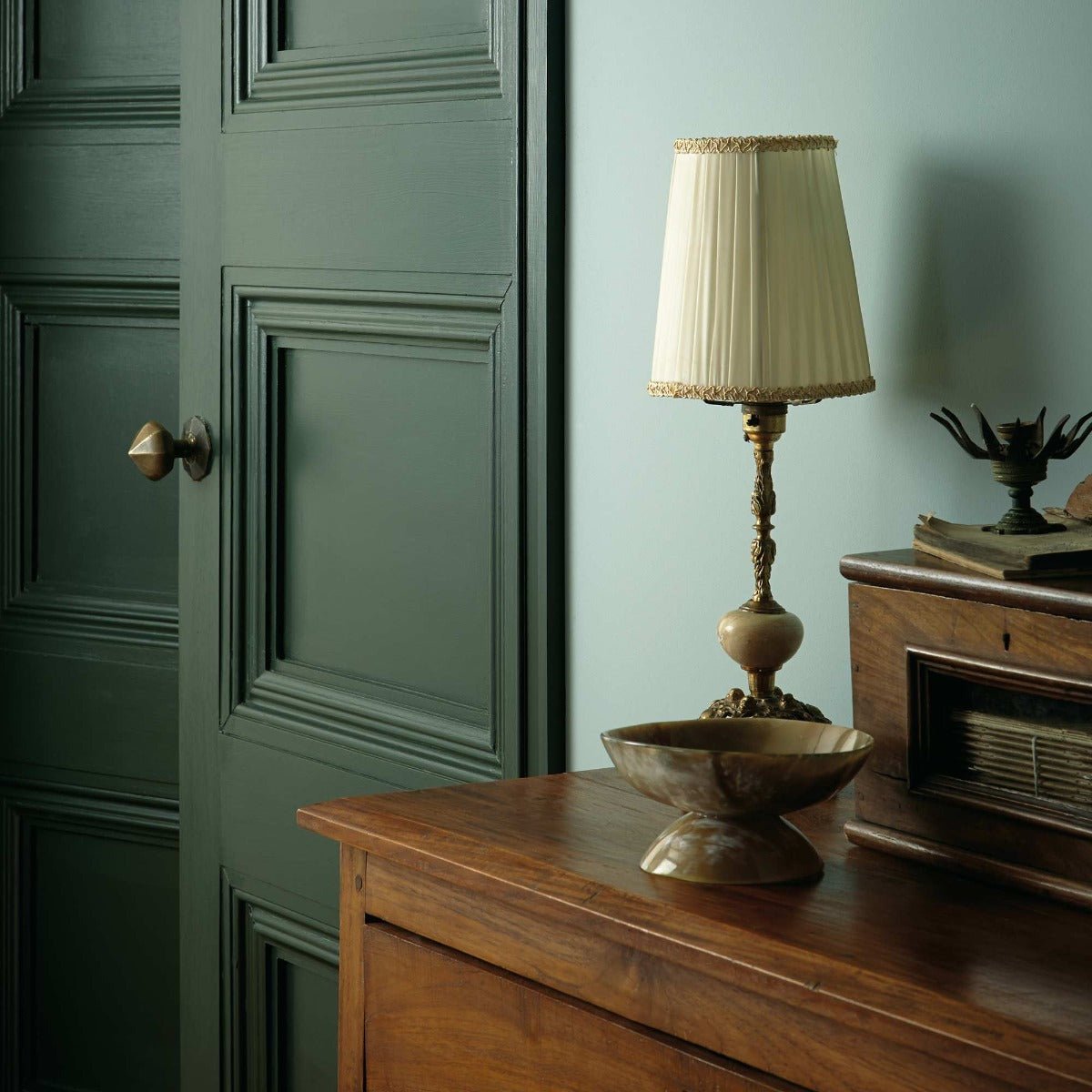 Antique brass malachite table lamp with cream pleated shade and ornate twisted metal base