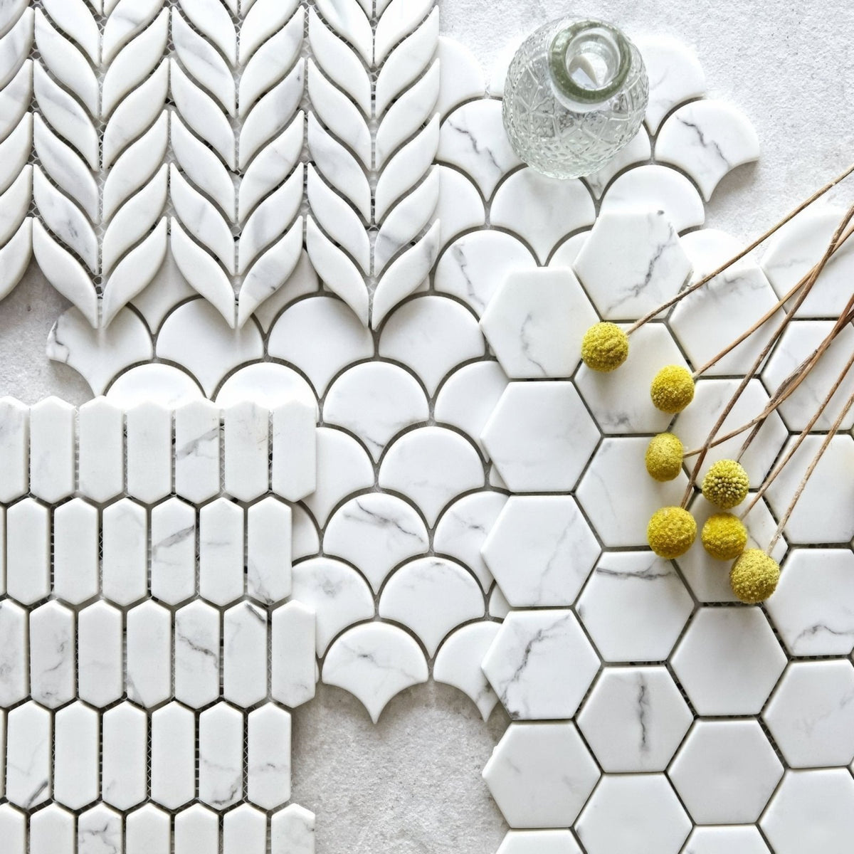 White marble mosaic tiles in various geometric patterns from malmo scallop white mosaic collection