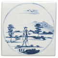 White ceramic tile with blue and white hand-painted man walking in a landscape scene titled man with stick in a landscape
