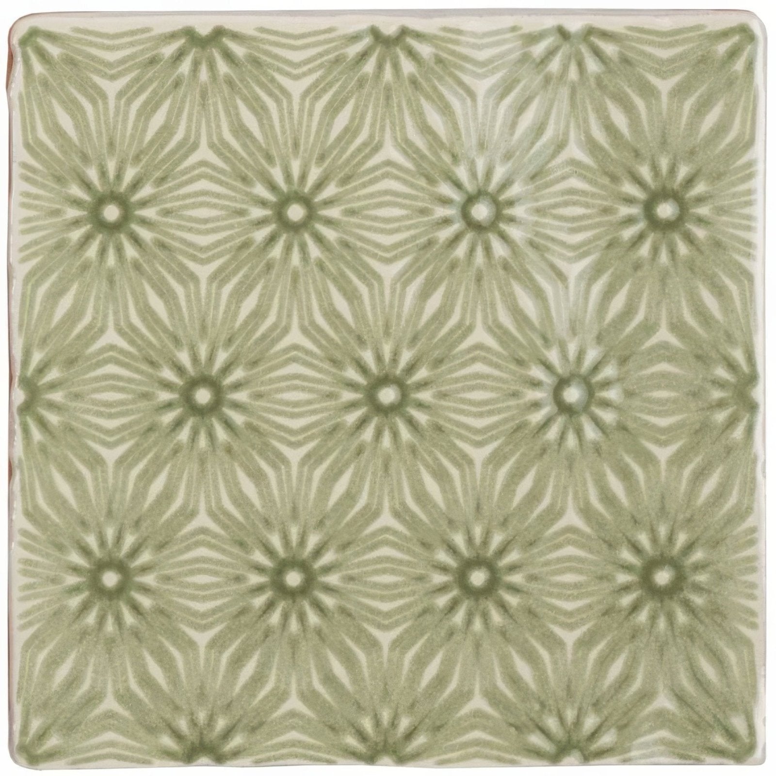 A square ceramic tile manoir fleur pumice with a repeating geometric pattern in muted sage green and off white
