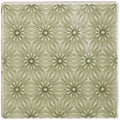 A square ceramic tile manoir fleur pumice with a repeating geometric pattern in muted sage green and off white