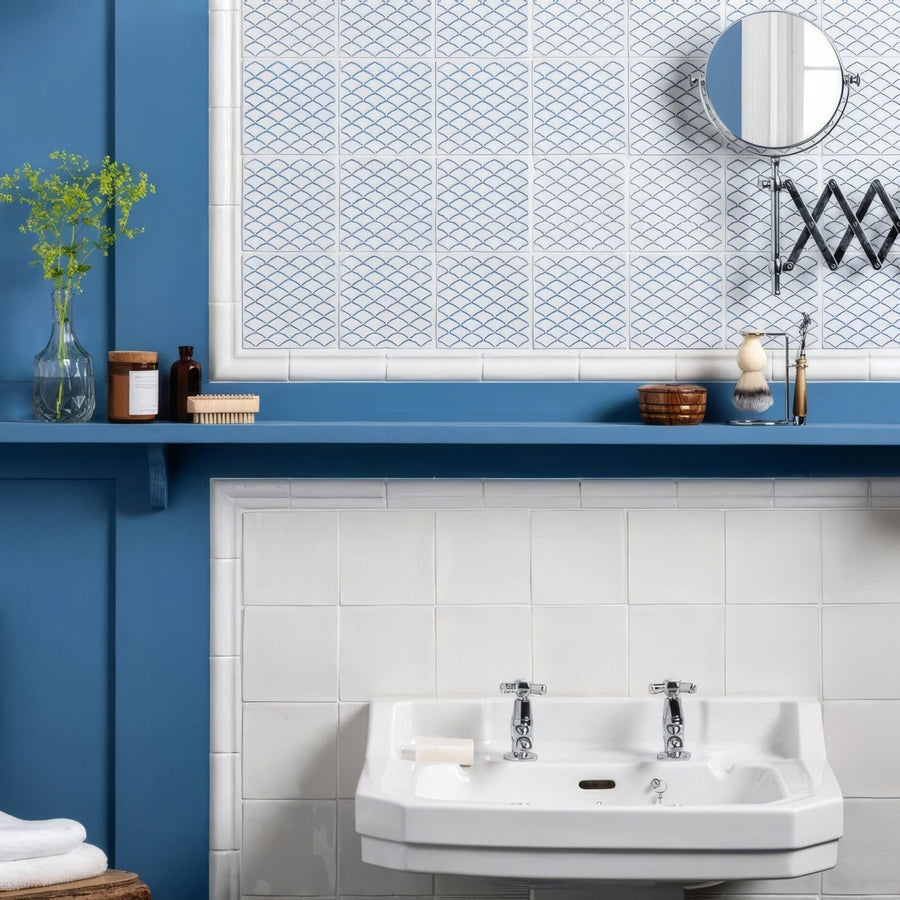White ceramic wall-mounted Manoir Nuage sink with chrome faucets on Papyrus for modern bathroom use