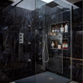 Marble Ocean Rock dark blue marble-effect tiles in a shower enclosure with glass panels and shelves