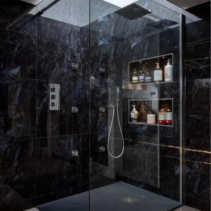 Modern shower enclosure with dark marble walls in Marble Ocean Rock 60 x 120cm and a glass door.