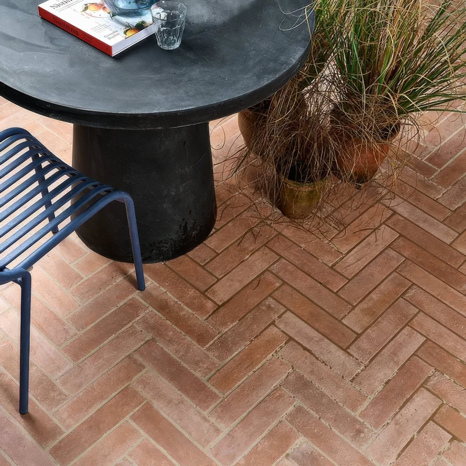 Terracotta brick patio with herringbone pattern featuring marlborough porcelain parquet natural tiles