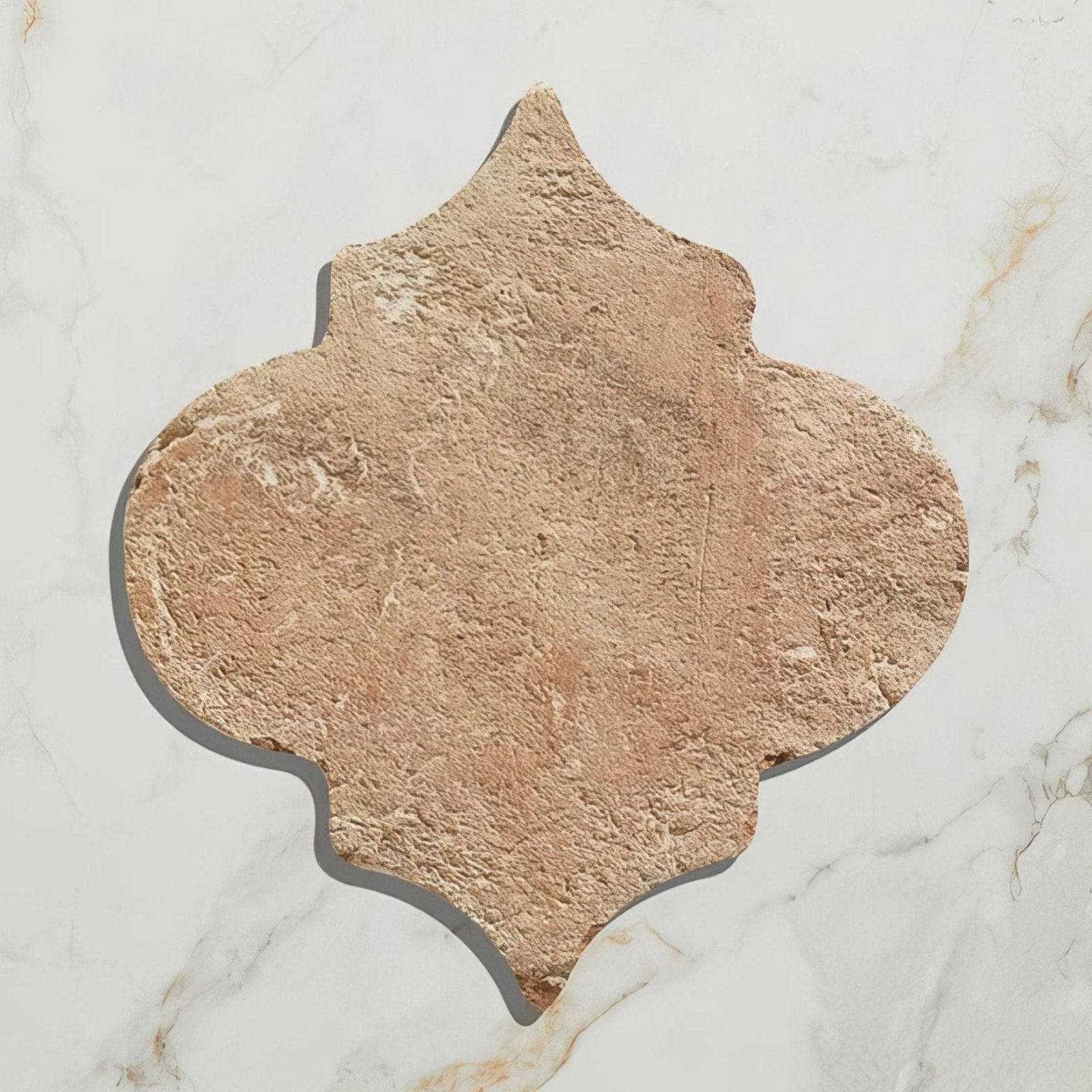 Tan textured marlborough terracotta arabesque stone tile in a quatrefoil shape for decorative flooring or walls