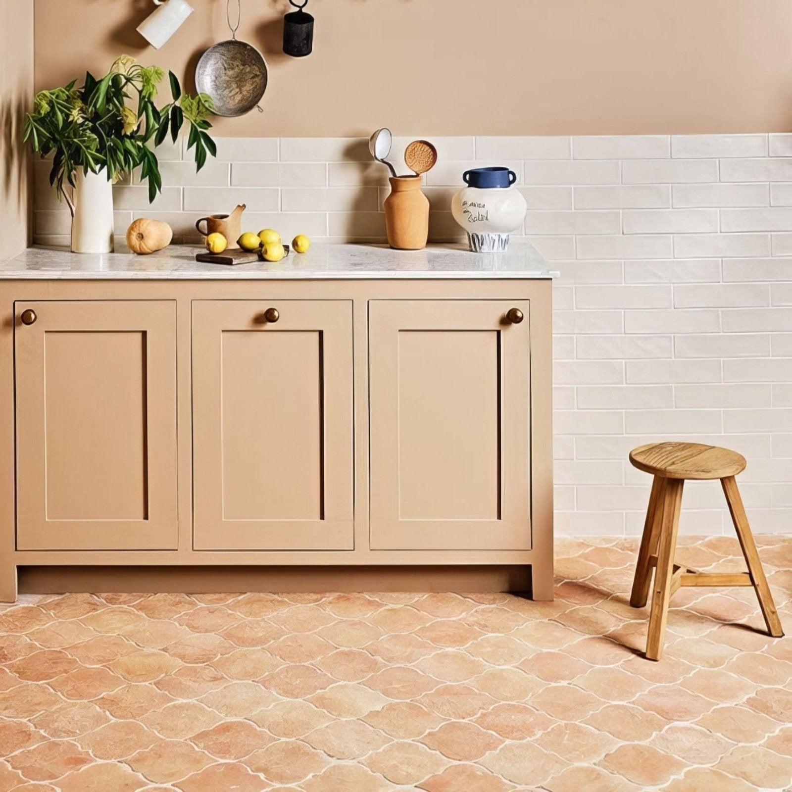 Beige shaker cabinet with marble countertop and brass knobs showcasing marlborough terracotta arabesque design