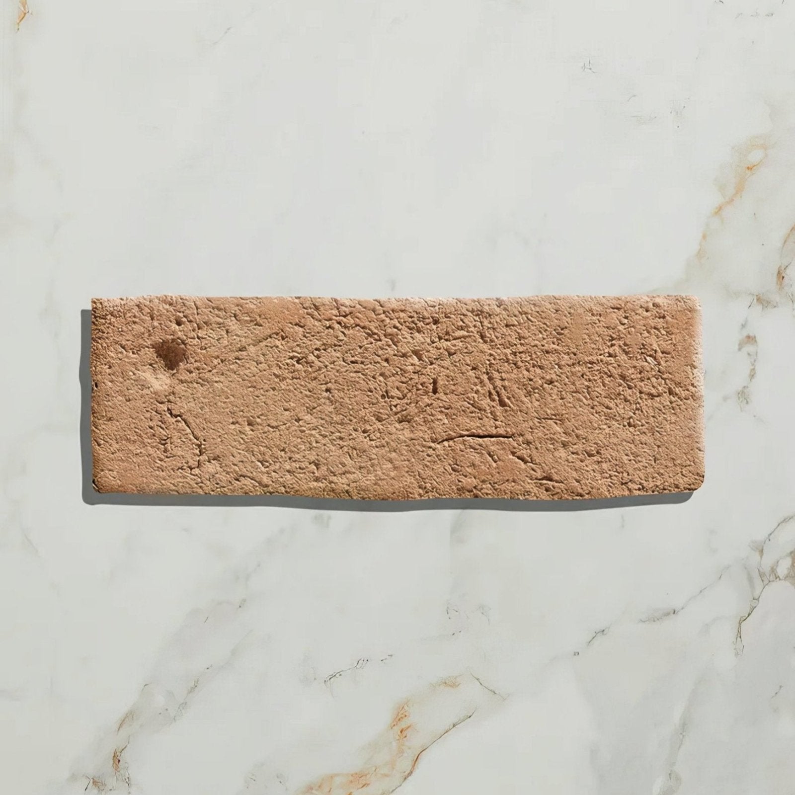 A rectangular marlborough terracotta bejmat brick with a textured earthy terracotta surface and natural imperfections
