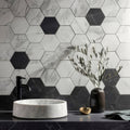 Marmi Nero Honed Hexagon Mosaic dark hexagonal marble mosaic backsplash with a white marble vessel sink and black tap