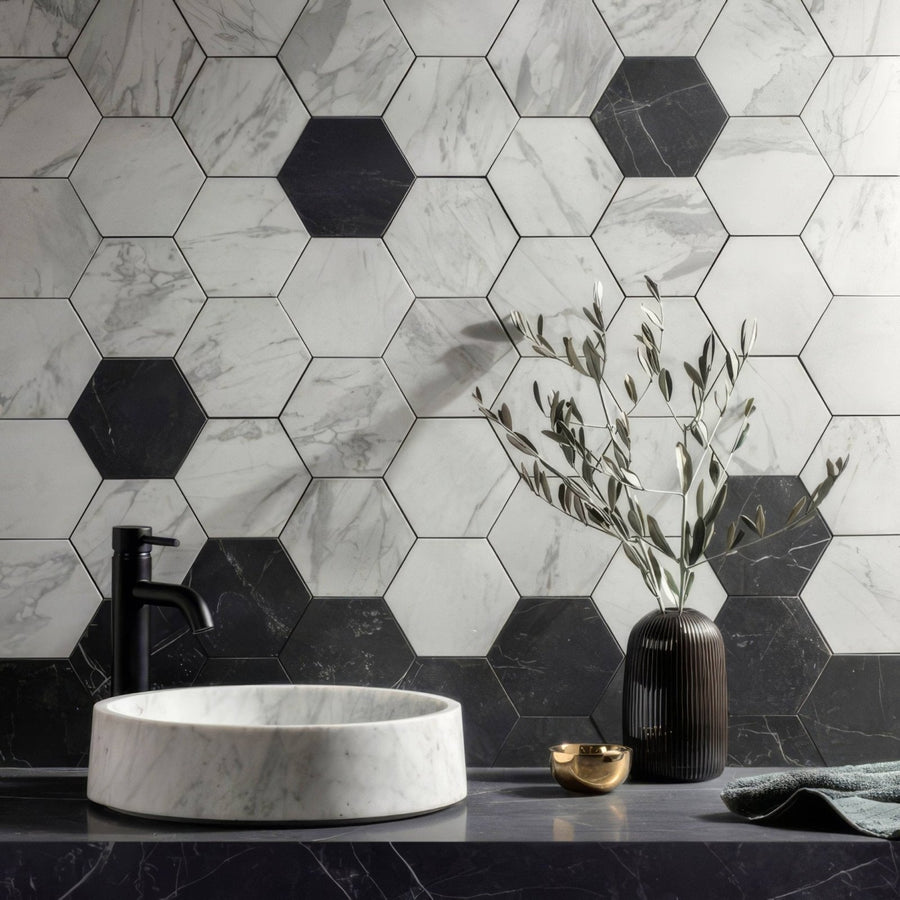 Marmi Nero Honed Hexagon Mosaic dark hexagonal marble mosaic backsplash with a white marble vessel sink and black tap