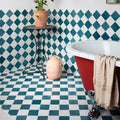 Red clawfoot ceramic bathtub with white interior and beige towel in maroc ceramic aquamarine collection