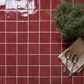 Red glossy ceramic tiles with white grout lines from maroc ceramic bordeaux collection for stylish wall or floor use