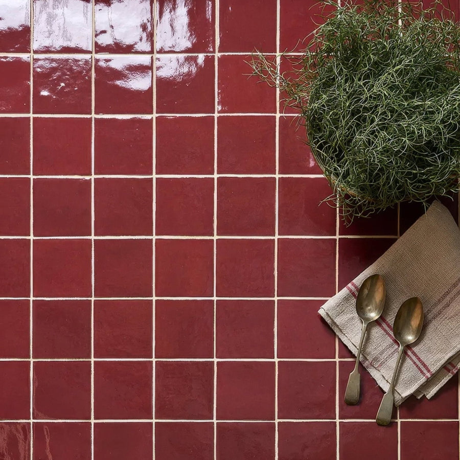 Red glossy ceramic tiles with white grout lines from maroc ceramic bordeaux collection for stylish wall or floor use