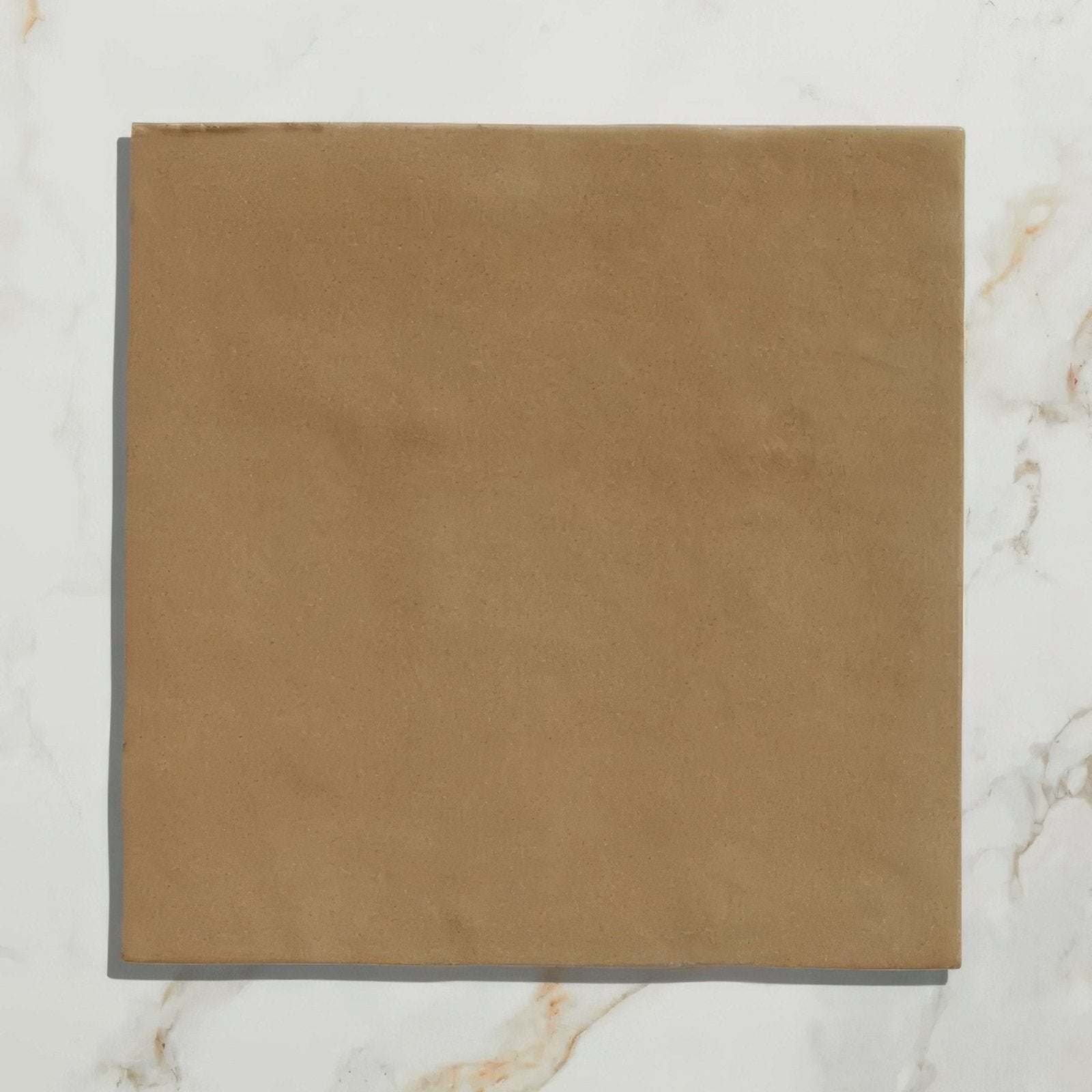 A square tan-colored suede tile with a soft textured surface for ceramic caramel maroc flooring