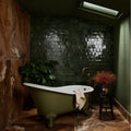 Olive green ceramic clawfoot bathtub with white interior and ornate feet from maroc ceramic forest collection