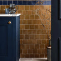 Warm amber-colored rectangular ceramic tiles with matte finish forming a wall in maroc ceramic khaki design