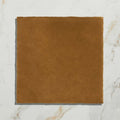 A square tan-colored suede ceramic tile with a soft textured surface from maroc ceramic khaki collection