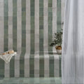 Green and white striped ceramic tiles form a textured modern bathroom wall in maroc ceramic mint design