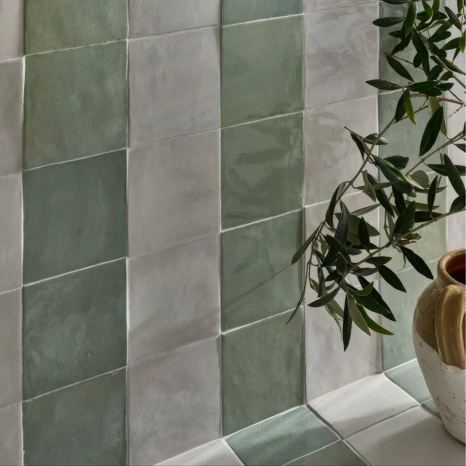Muted green and gray square ceramic tiles with a matte textured finish in maroc ceramic mint style