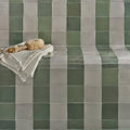 White textured towel with a soft fluffy bath brush resting on top in the maroc ceramic mint collection