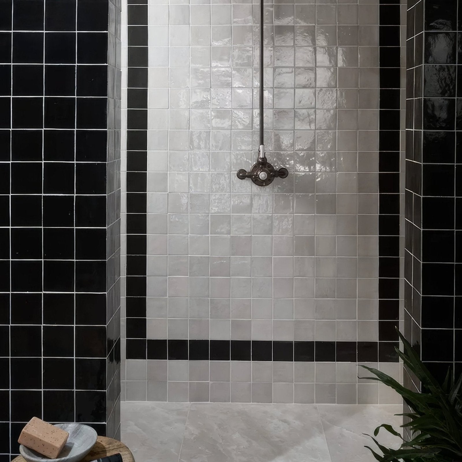 Maroc Ceramic Nero black and white ceramic tiles with a vintage brass showerhead