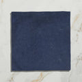 A square navy blue suede coaster from maroc ceramic oltremare perfect for protecting surfaces