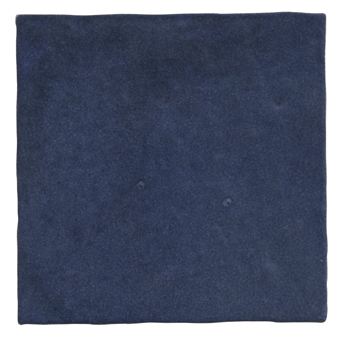 
Dark blue suede square napkin complementing maroc ceramic oltremare dinnerware collection