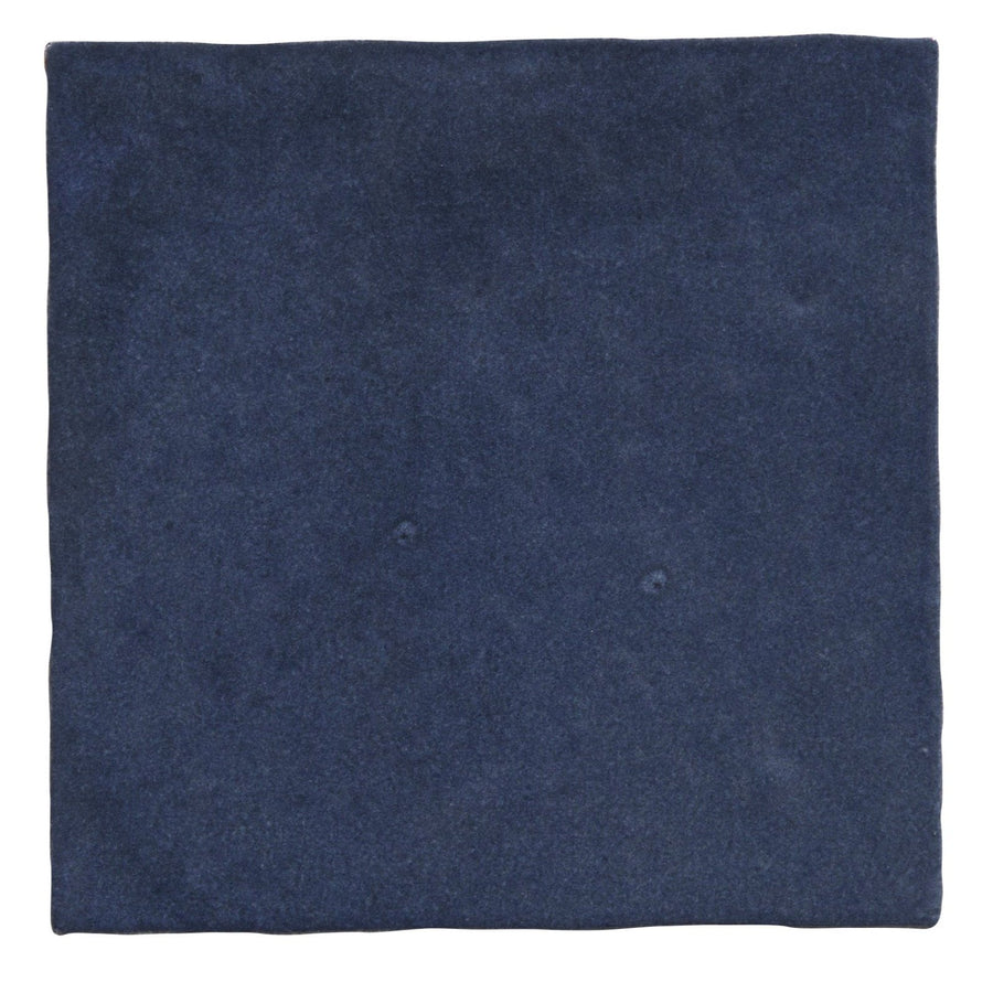 Dark blue suede square napkin complementing maroc ceramic oltremare dinnerware collection