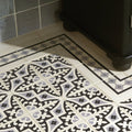 Marrakech Border Light Grey and Black on White shown as flooring