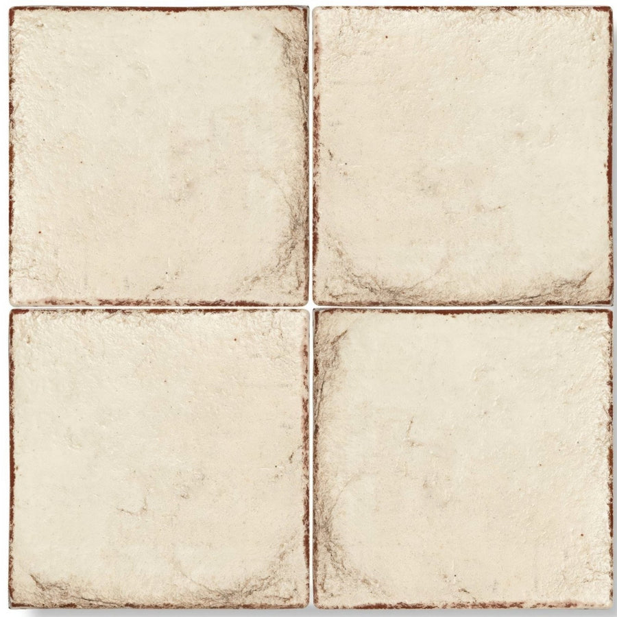 Cream-colored textured square terracotta base tile with rustic brown edges for flooring and wall use