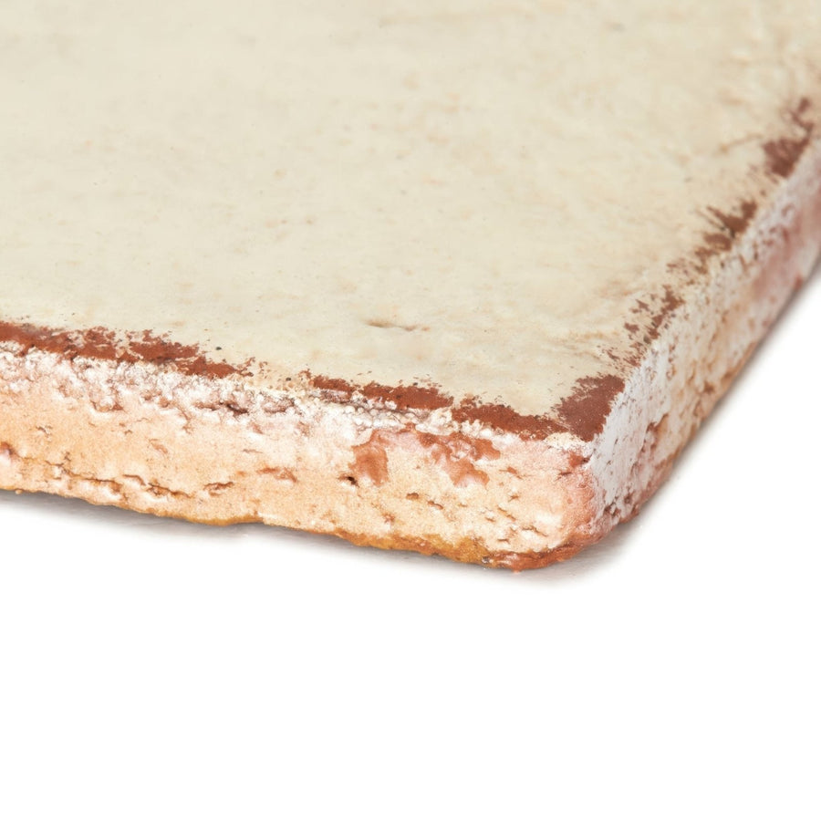 A rustic off-white stone slab tile with weathered edge and brown undertones part of marrakech cream terracotta base tiles