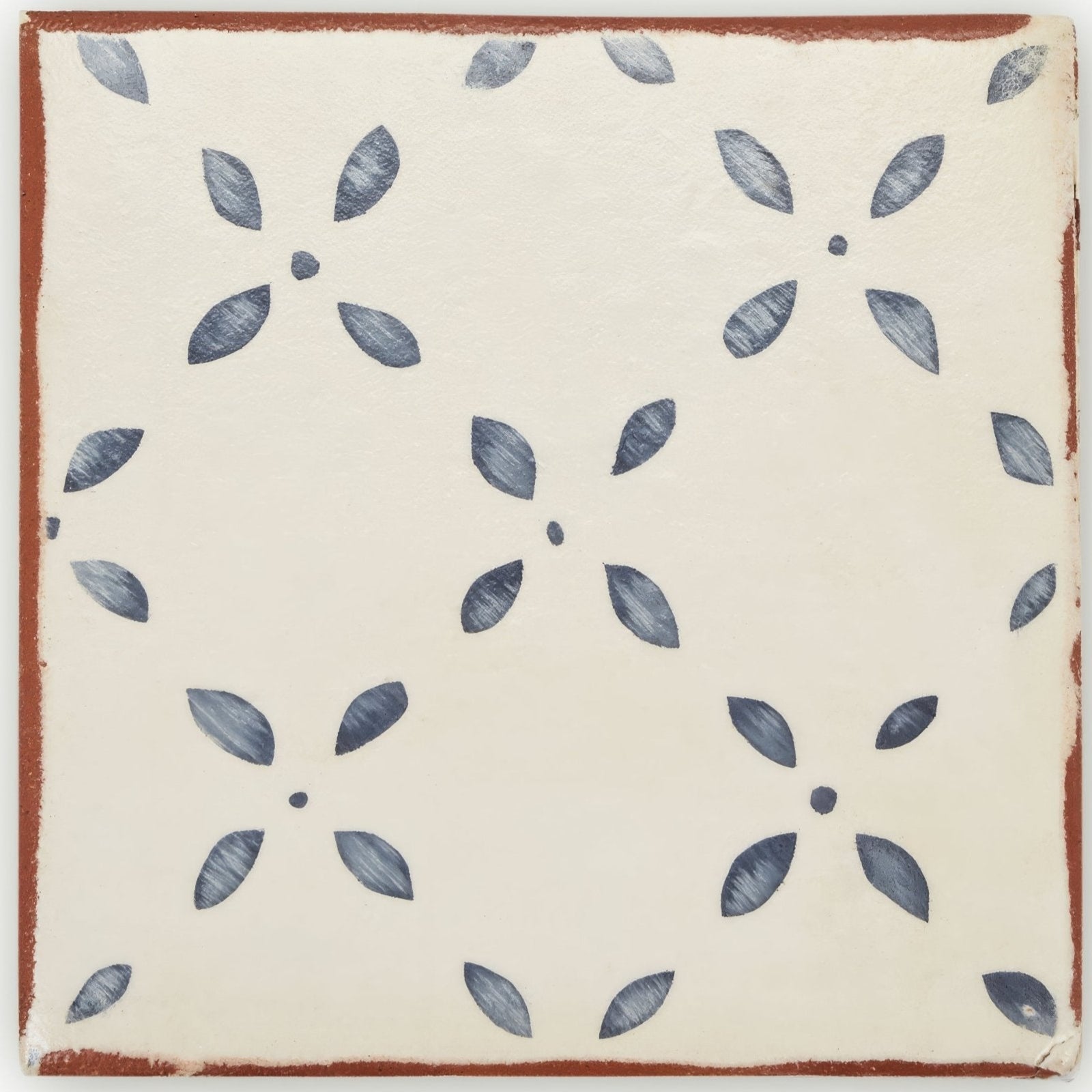 Cream-colored ceramic terracotta tile with rustic brown border and hand-painted dark gray leaf floral motifs Marrakech El Hara