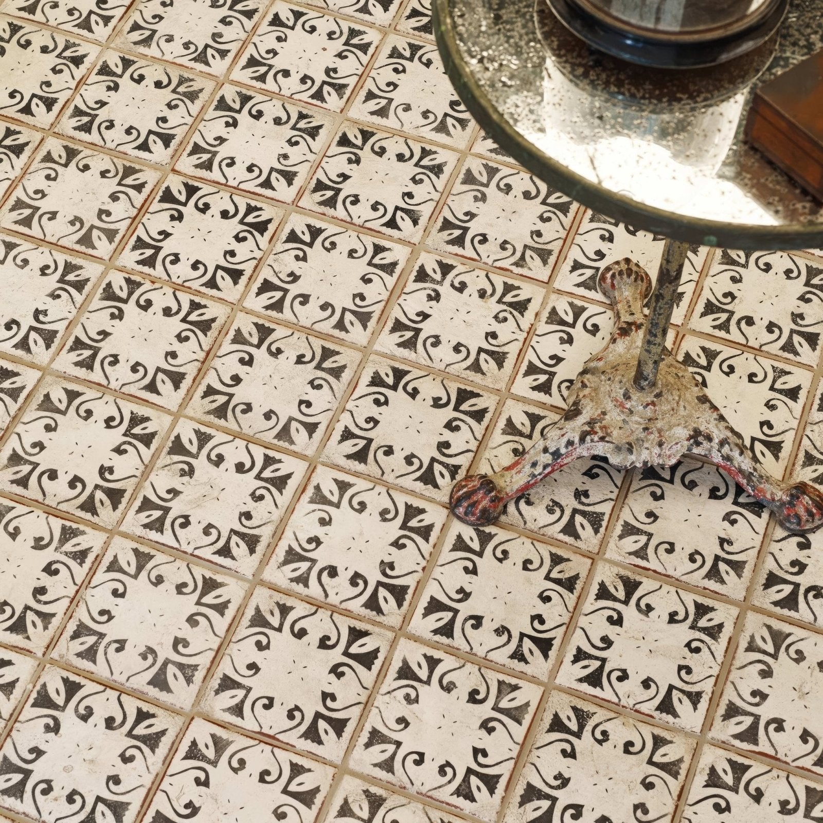 Black and white ornate patterned terracotta floor tiles with vintage distressed finish from the Marrakech hammam collection