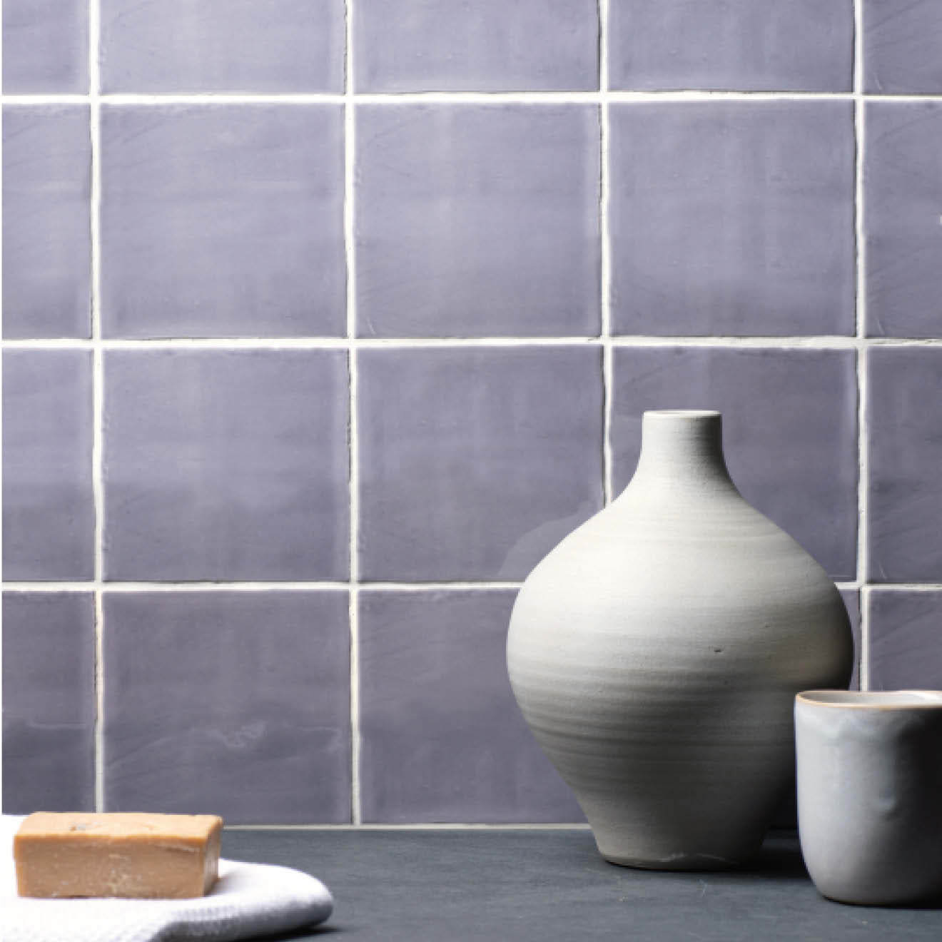 A matte gray ceramic vase with a rounded body and slender neck featured in marsh field tile product design