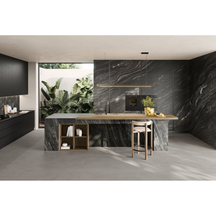 Marvel Diva Black Tempest Velvet dark grey marble-effect tiles with a kitchen island and wooden countertop