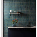 Teal-blue vertical-striped ceramic tiles with subtle metallic grout lines from matchstick forest collection