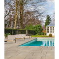 Beige rectangular matravers sandstone sawn stone pavers lining the pool deck for outdoor use