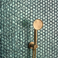 Medak Glass Mosaic teal glass mosaic with a gold showerhead