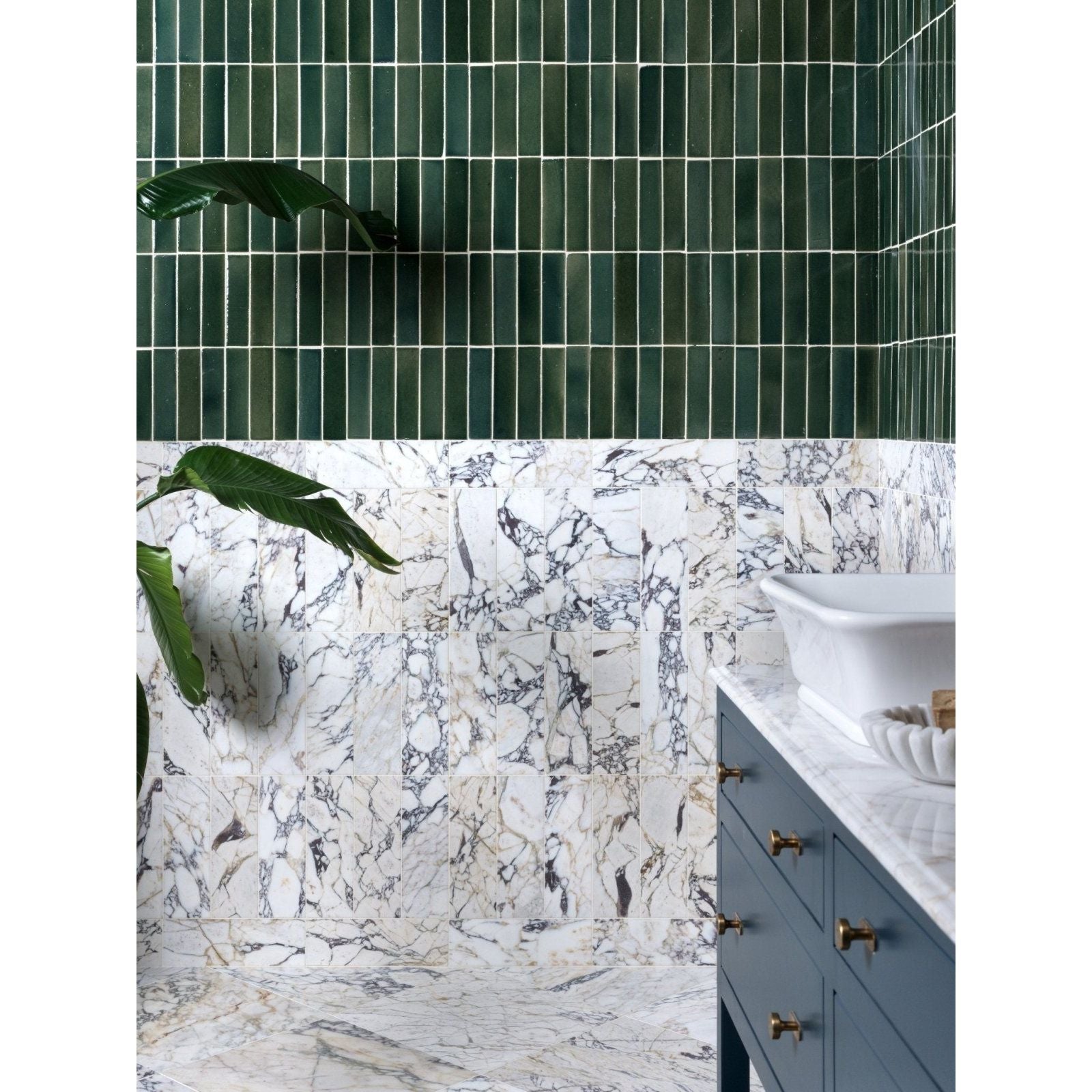 Dark green rectangular ceramic tiles with white grout create a modern wall accent above medici viola marble honed brick vanity