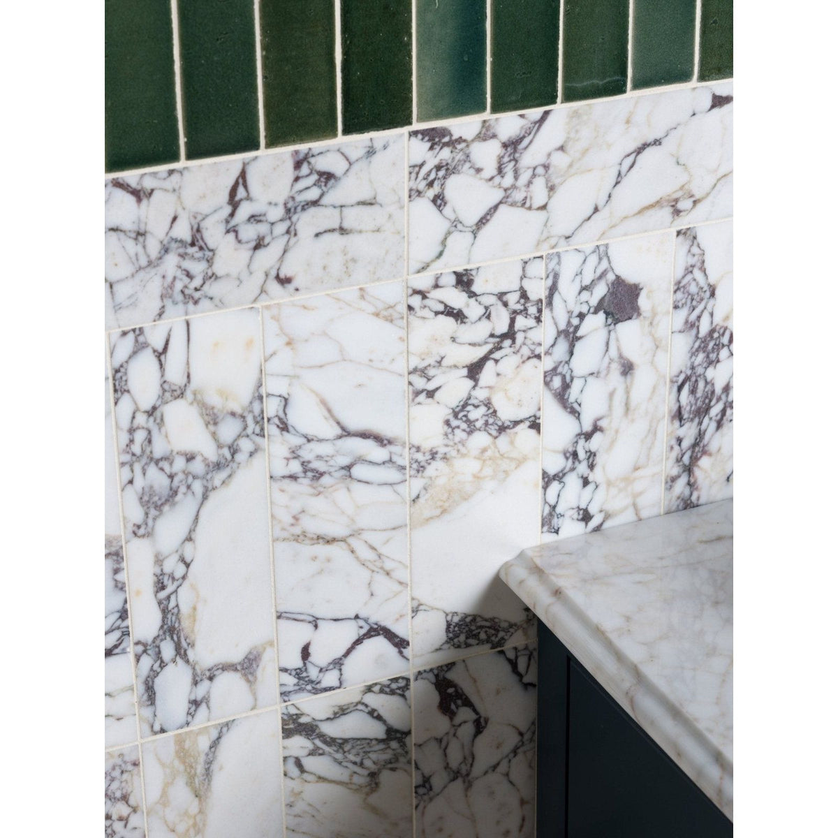 Medici viola marble honed brick tiles in white with black and gray veining topped by dark green rectangular tiles