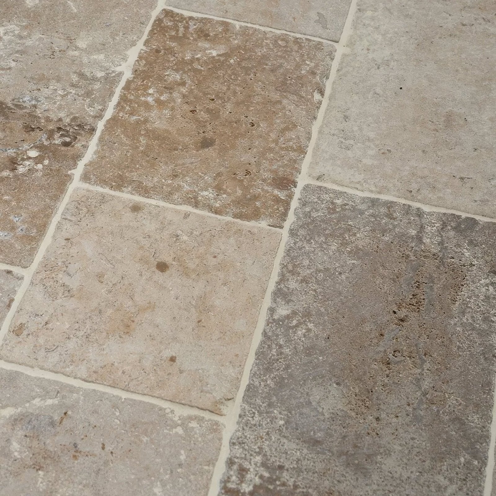 Natural stone tiles of vieux bourgogne limestone cobbles with weathered finish in beige tan and gray tones