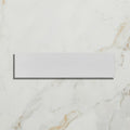 Medina Brick Porcelain Latte off-white porcelain brick tile on a marble surface