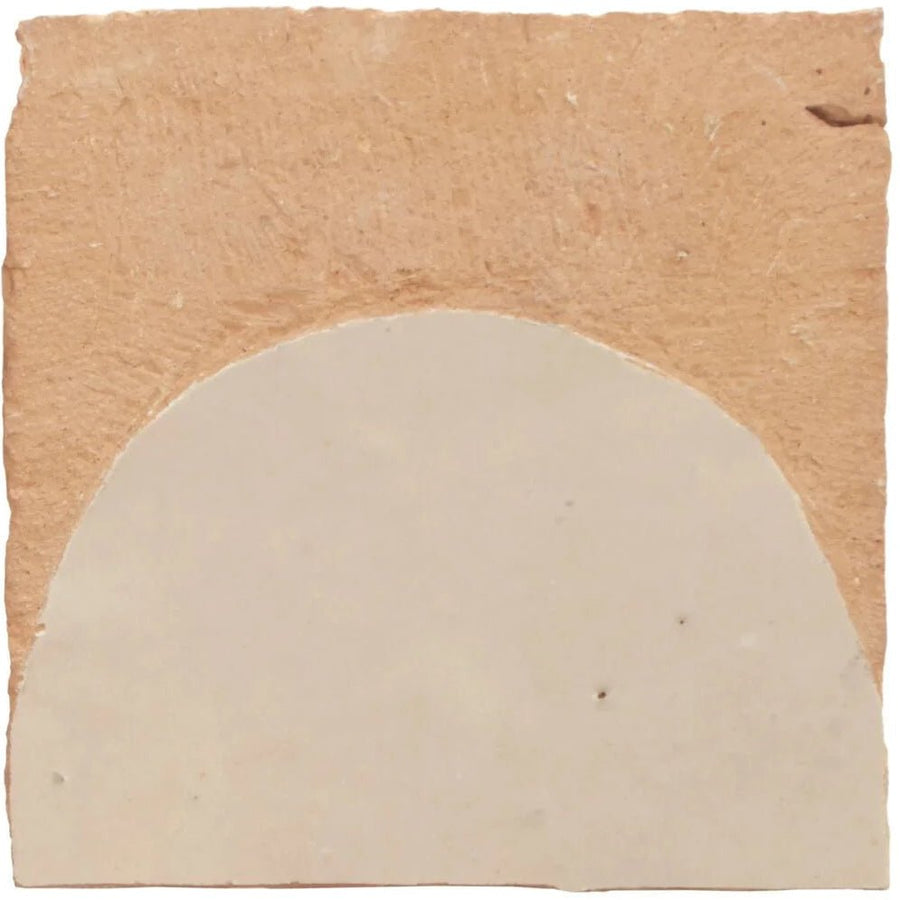 A beige semi-circular Medina cloudy white belen handmade Moroccan zellige tile with textured surface and irregular edges