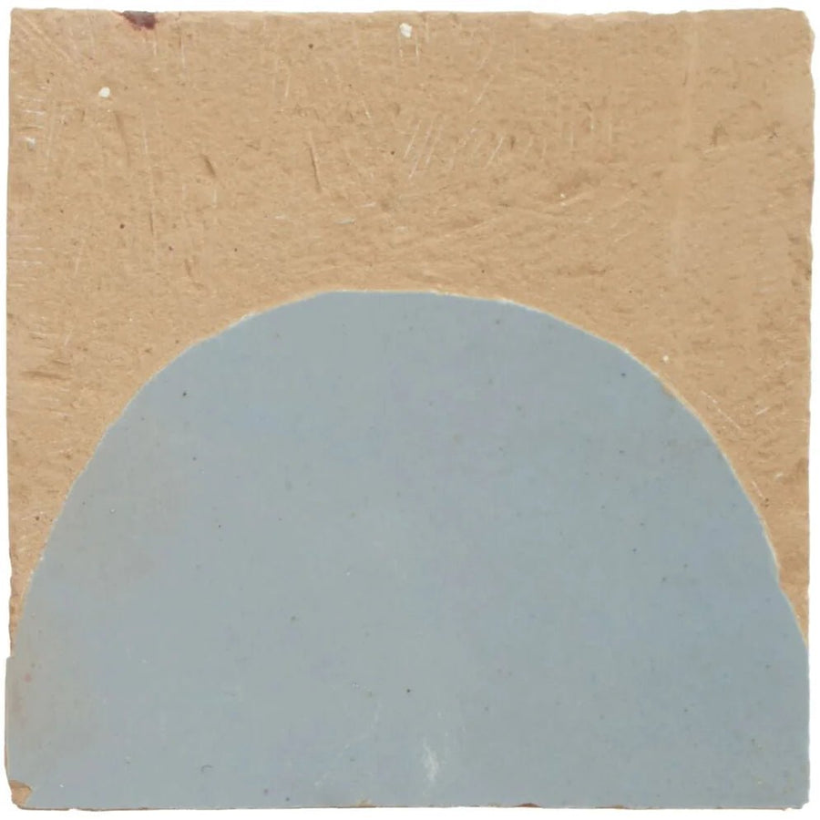 A square ceramic medina cornflower blue belen handmade moroccan zellige tile with a matte light blue semi circular design on beige