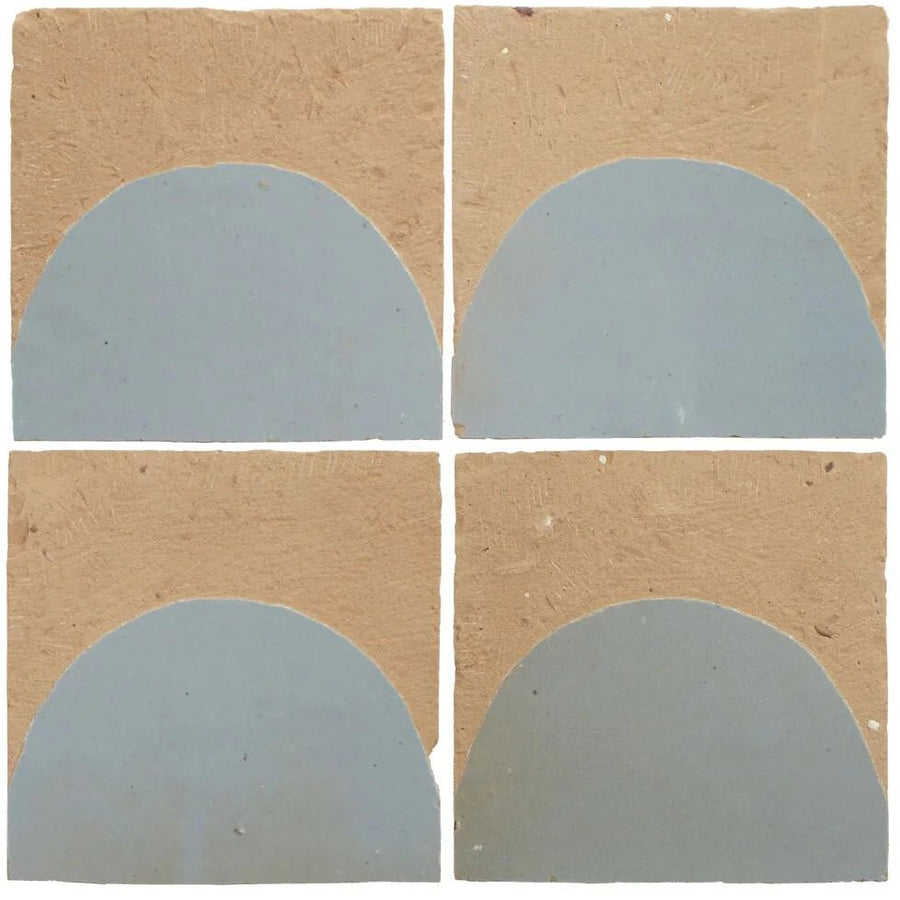 Four handcrafted Medina cornflower blue zellige tiles with tan textured background and matte semicircular design