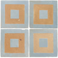Set of four handmade Moroccan zellige ceramic tiles featuring layered geometric design in cornflower blue and tan
