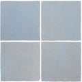 Four square matte-finished light blue ceramic tiles from medina cornflower blue handmade moroccan zellige tile set