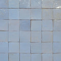 Medina cornflower blue square handmade moroccan zellige tiles in light blue ceramic with a glossy finish arranged in a grid