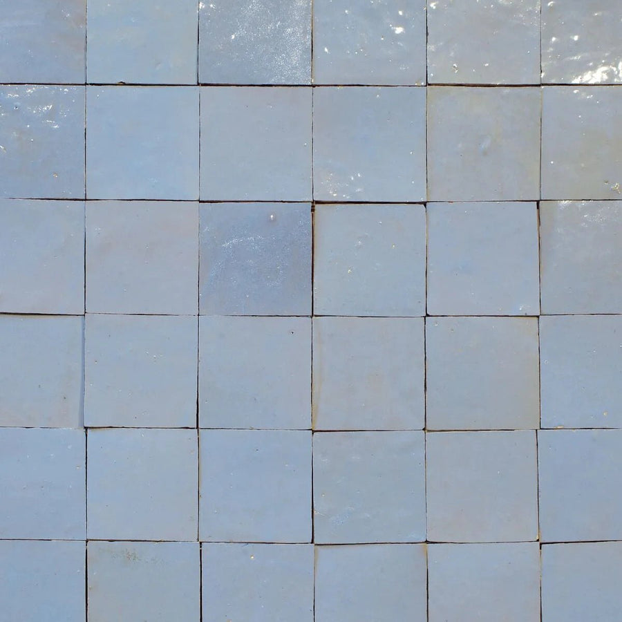 Medina cornflower blue square handmade moroccan zellige tiles in light blue ceramic with a glossy finish arranged in a grid